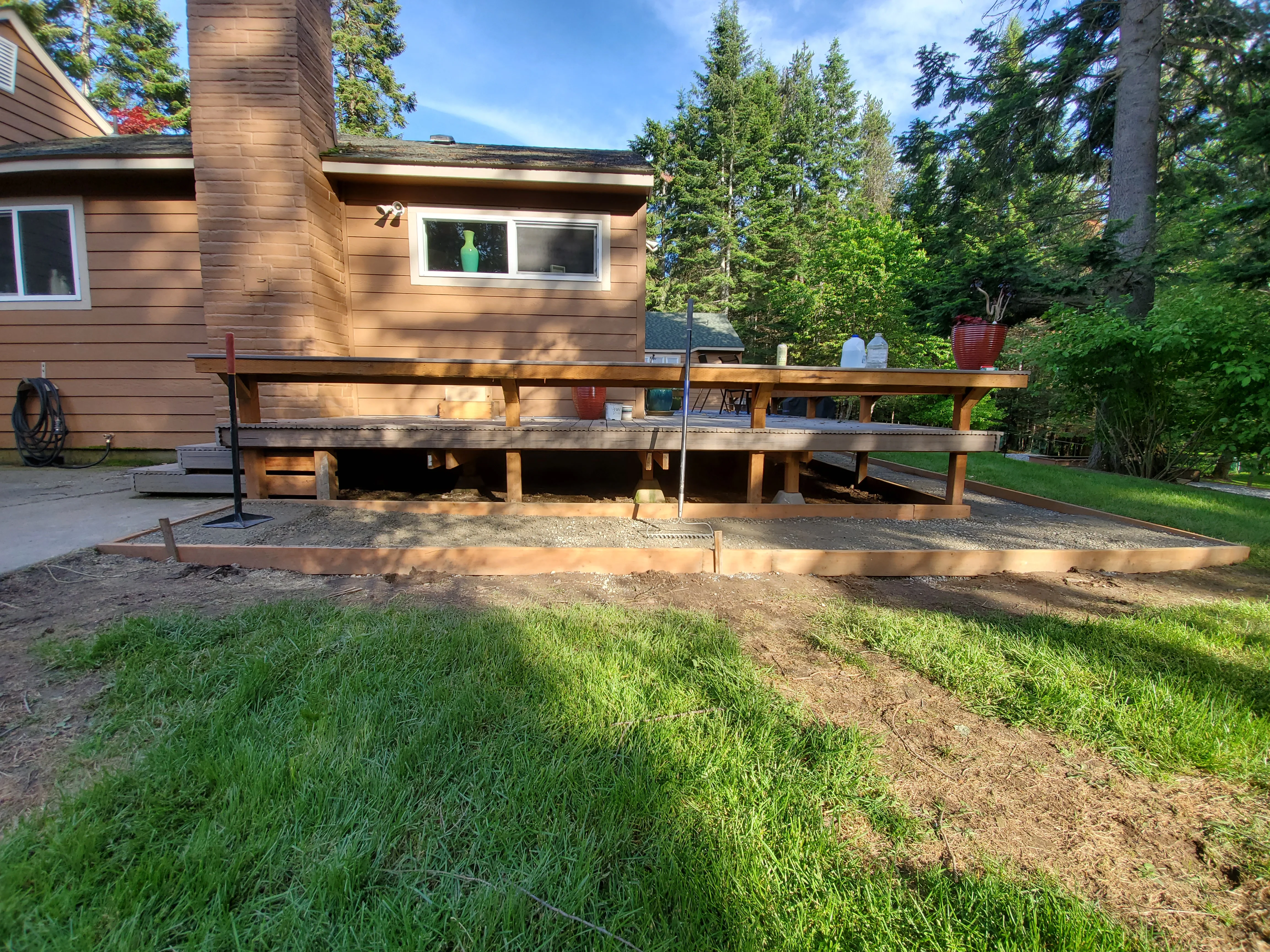 Residential deck foundation with gravel base and timber framing on prepared ground